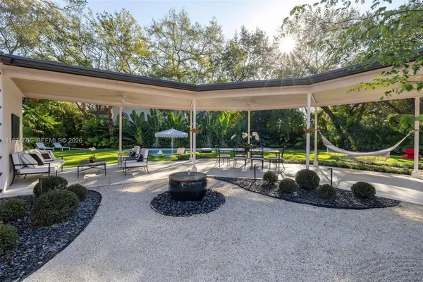 a view of swimming pool with outdoor seating and yard