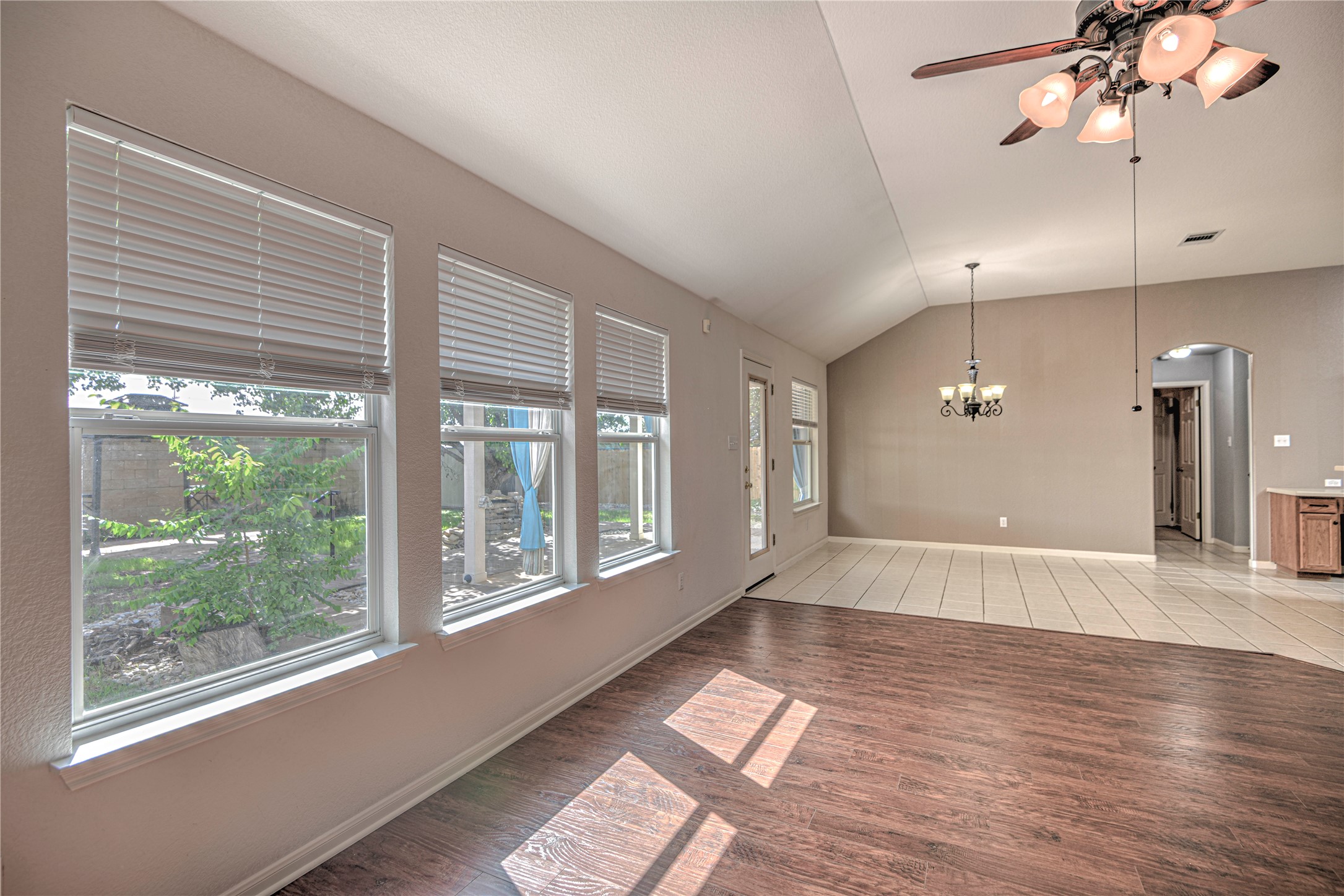 1900 Rutherford Drive Leander, TX 78641 - Photo 13 of 38 a view of an empty room with a window and wooden floor