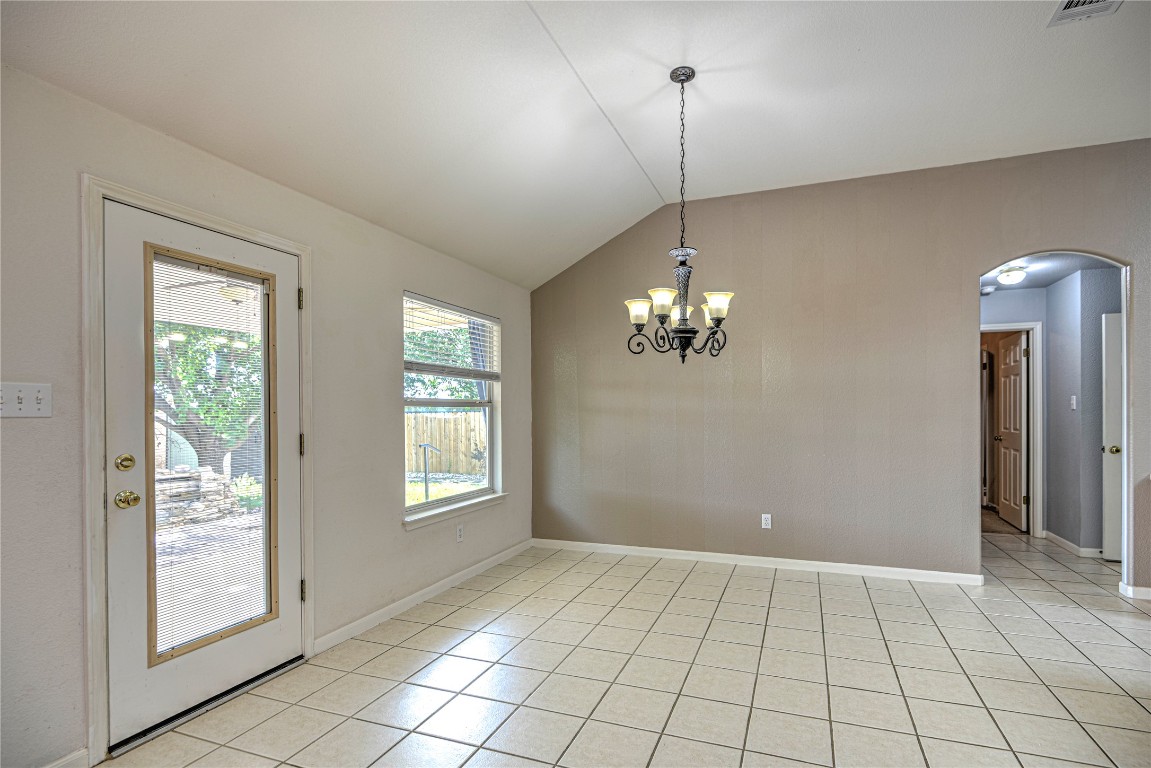 1900 Rutherford Drive Leander, TX 78641 - Photo 15 of 38 a view of an empty room with window and chandelier fan