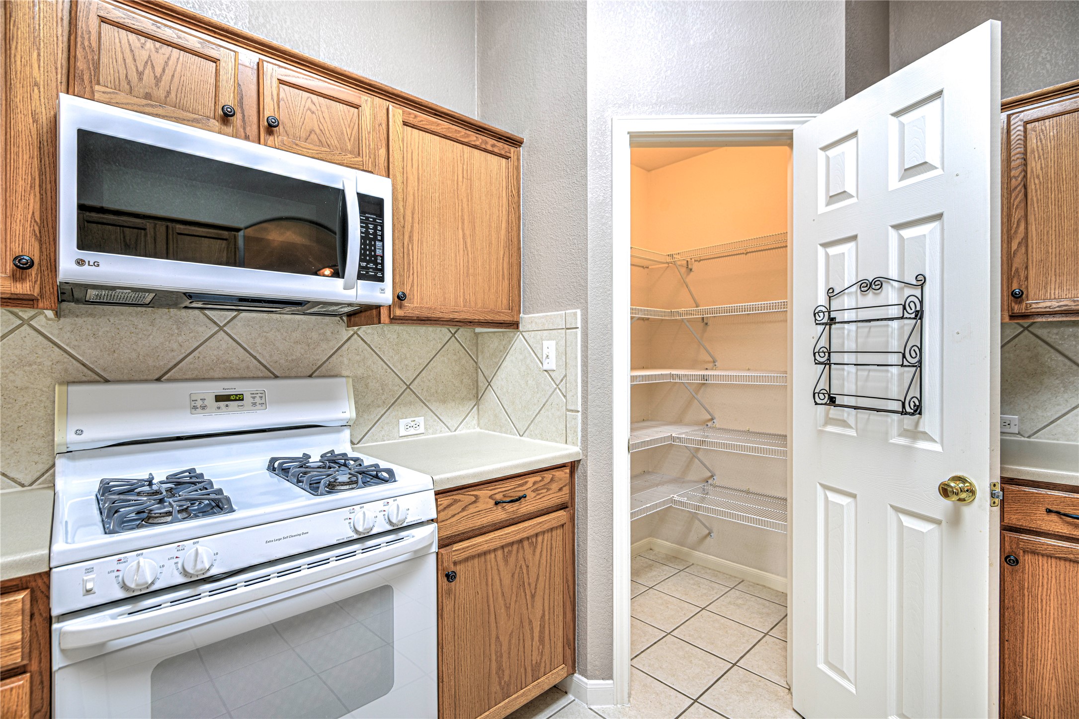 1900 Rutherford Drive Leander, TX 78641 - Photo 18 of 38 a kitchen with a stove and a microwave