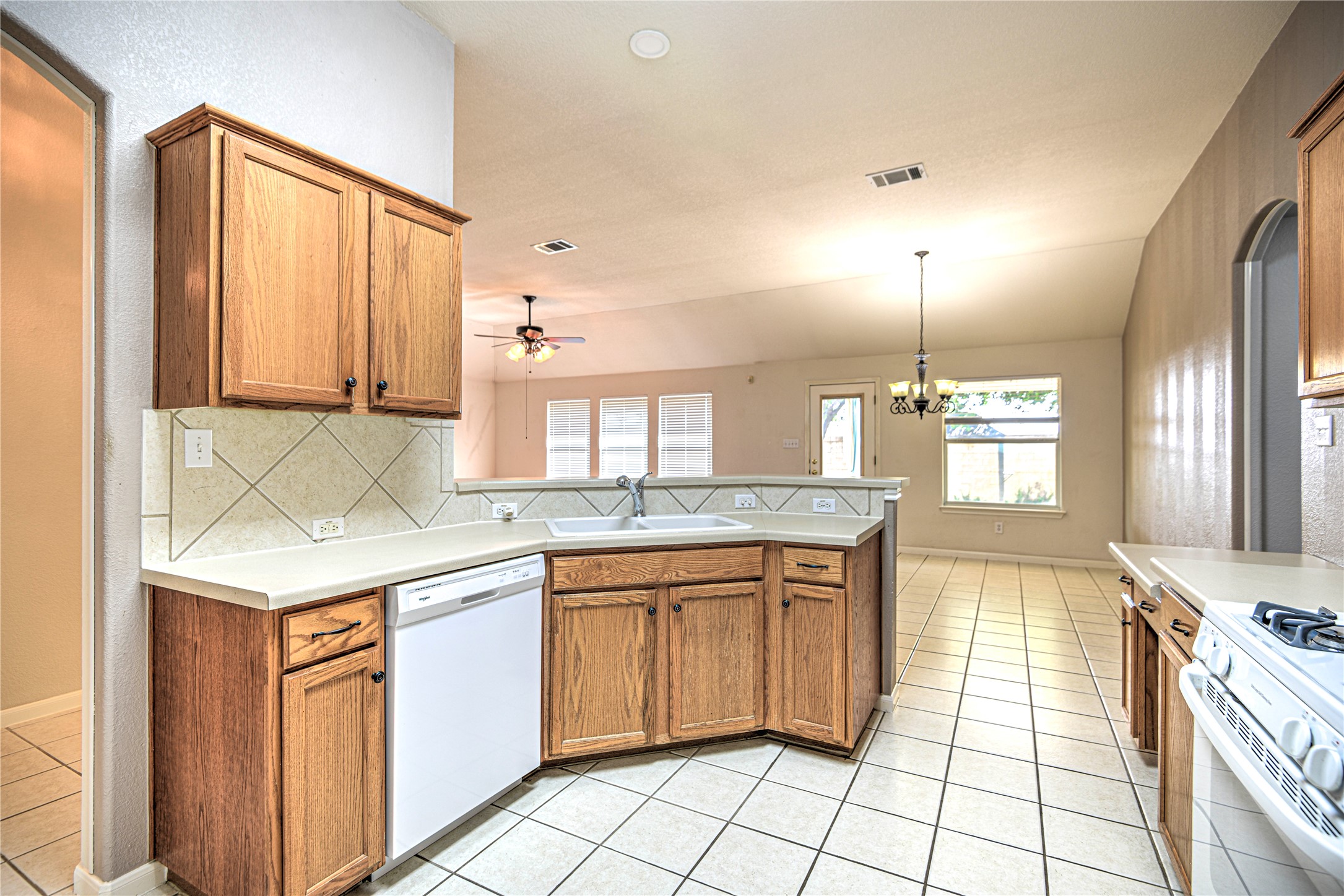 1900 Rutherford Drive Leander, TX 78641 - Photo 19 of 38 a kitchen with a sink stove and cabinets