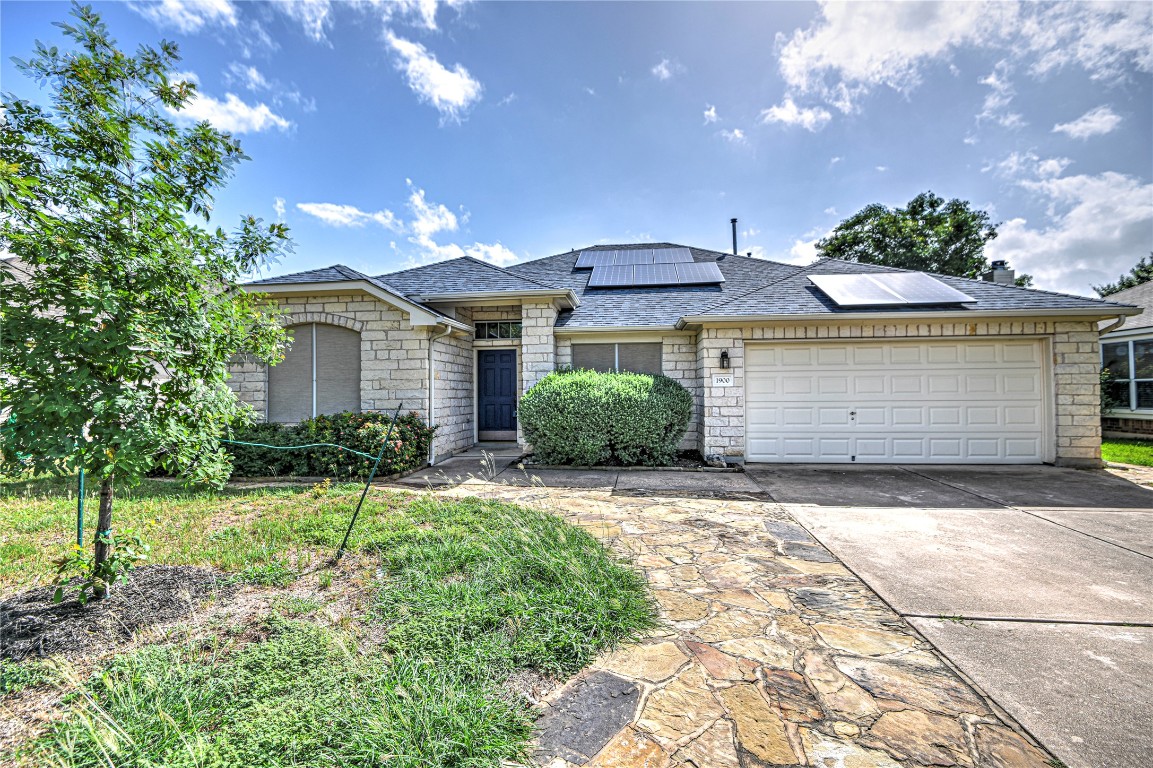 1900 Rutherford Drive Leander, TX 78641 - Photo 2 of 38 a front view of a house with a yard and garage
