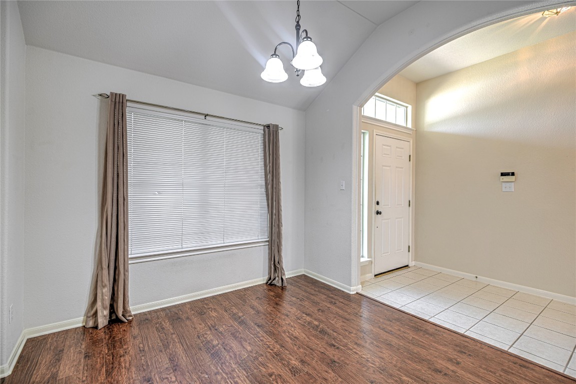 1900 Rutherford Drive Leander, TX 78641 - Photo 9 of 38 an empty room with wooden floor cabinet and windows