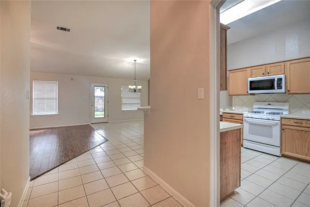 a view of a kitchen with microwave and stove top oven