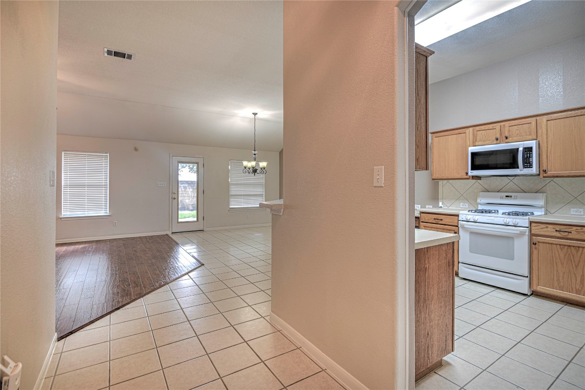 1900 Rutherford Drive Leander, TX 78641 - Photo 10 of 38 a view of a kitchen with microwave and stove top oven