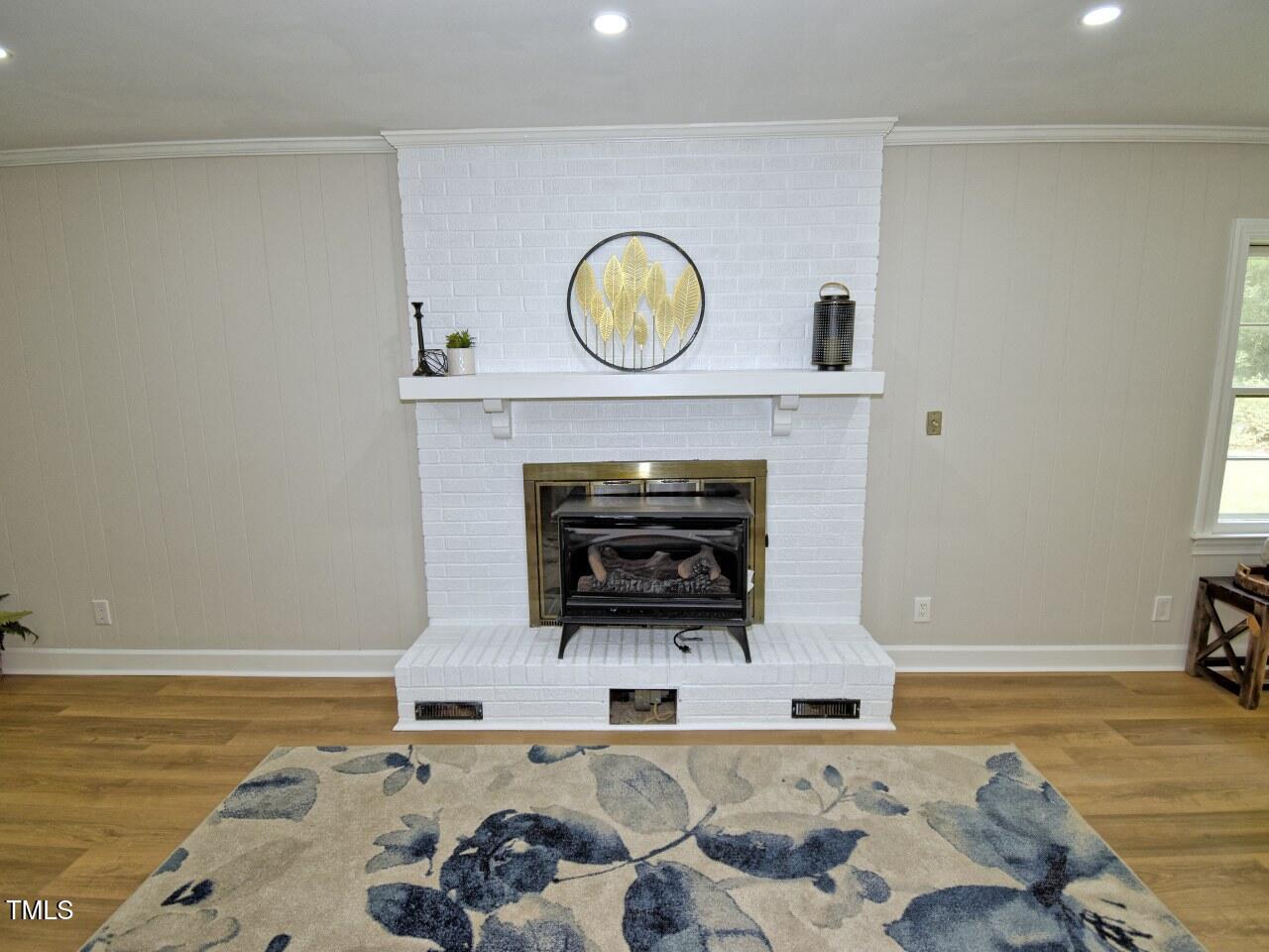 906 Perry Road Zebulon, NC 27597 - Photo 15 of 36 a living room with furniture and a fireplace