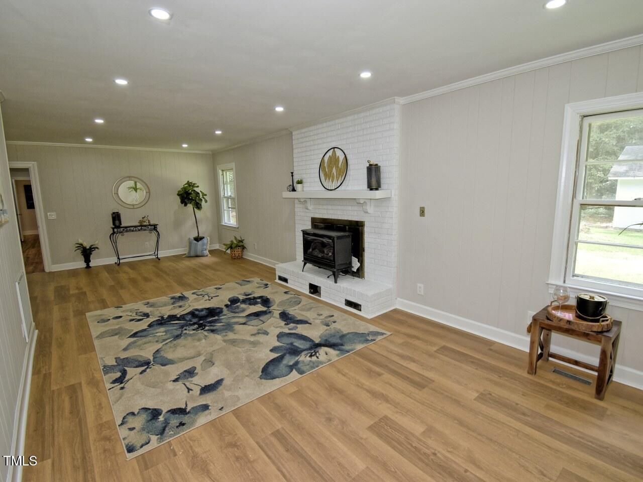 906 Perry Road Zebulon, NC 27597 - Photo 16 of 36 a living room with furniture and a fireplace