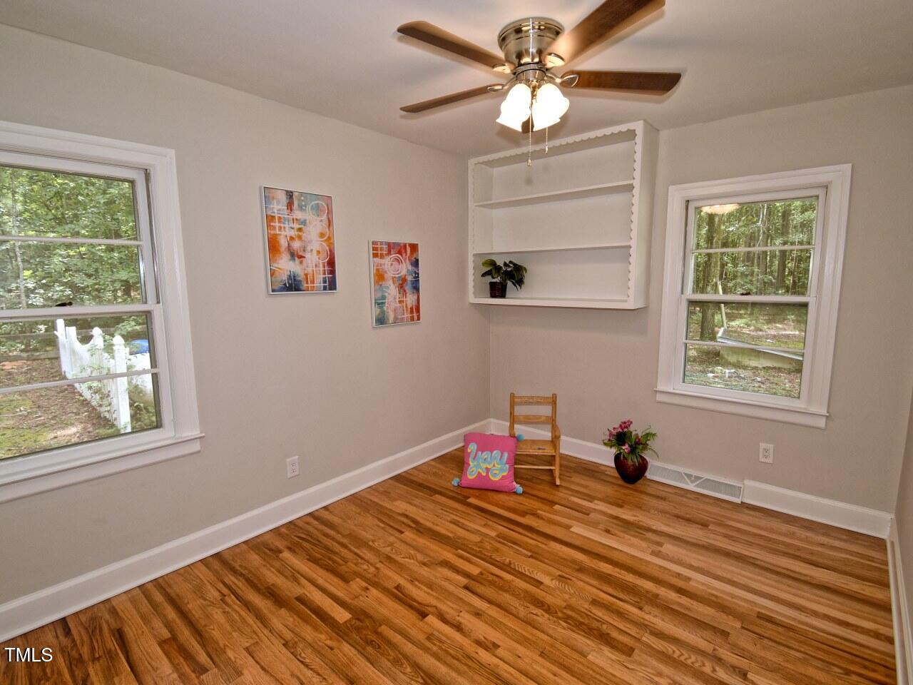 906 Perry Road Zebulon, NC 27597 - Photo 24 of 36 a bedroom with bed and a window