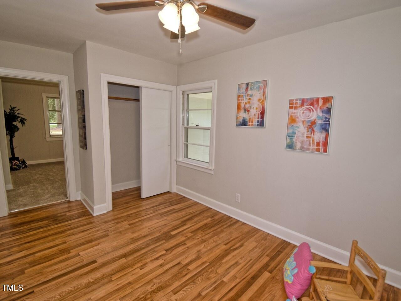 906 Perry Road Zebulon, NC 27597 - Photo 25 of 36 a view of an empty room with wooden floor