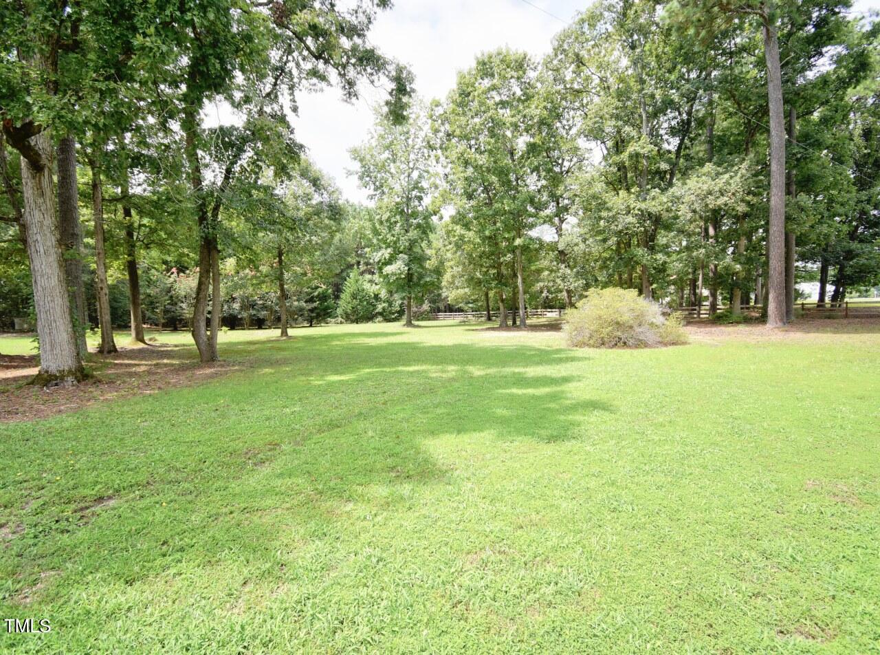 906 Perry Road Zebulon, NC 27597 - Photo 28 of 36 a view of field with trees