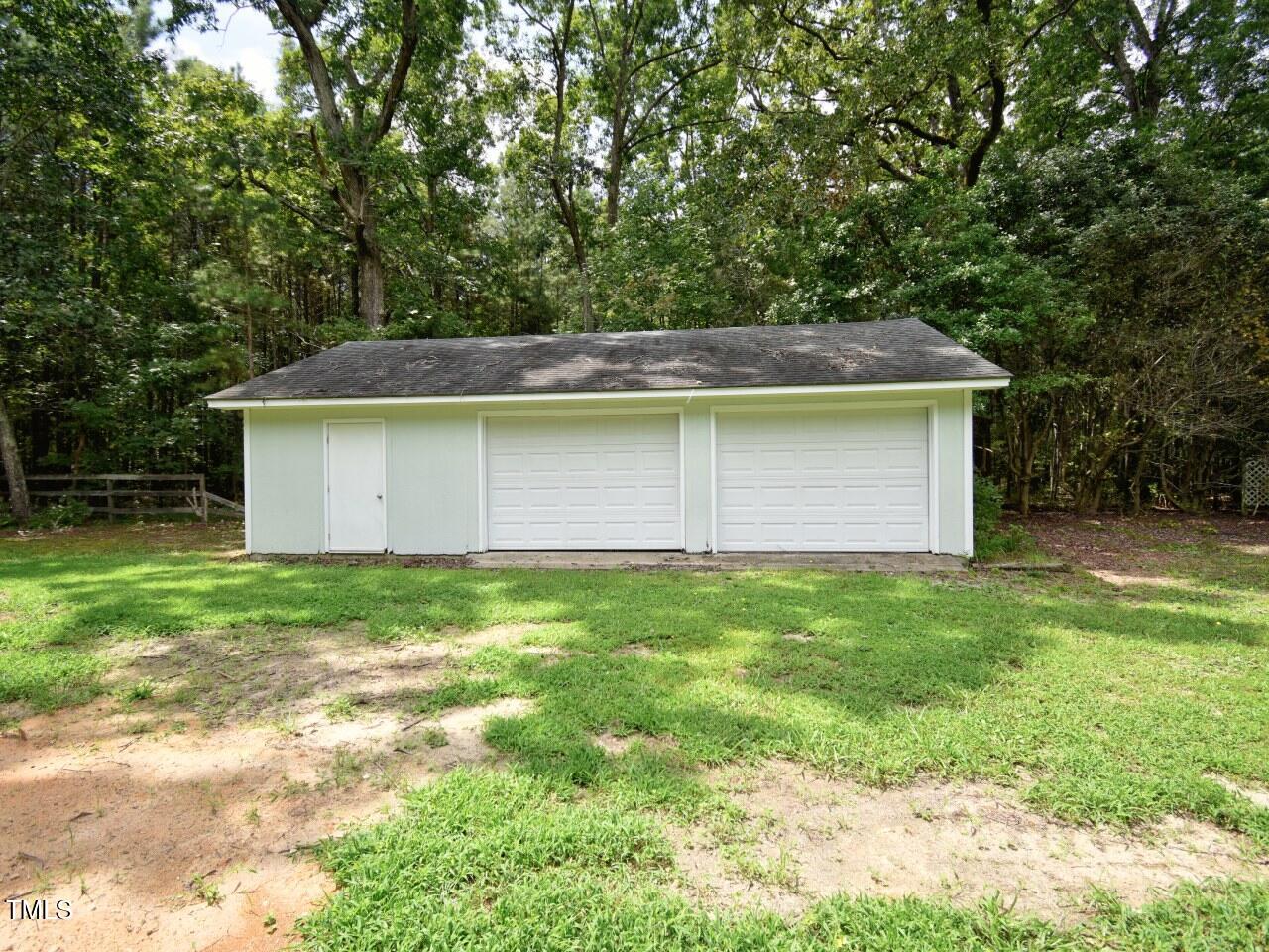 906 Perry Road Zebulon, NC 27597 - Photo 32 of 36 a backyard of a house with lots of green space