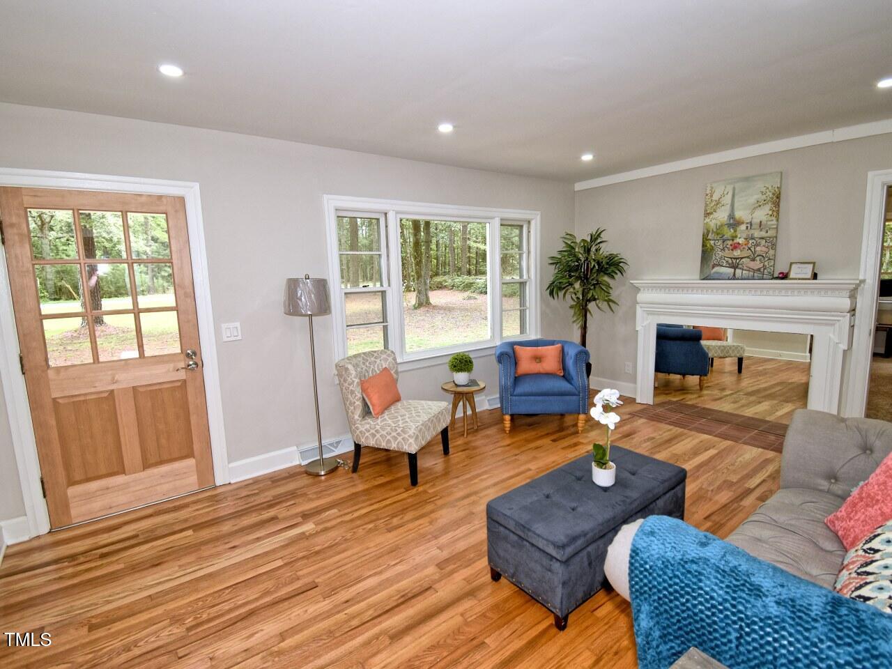 906 Perry Road Zebulon, NC 27597 - Photo 4 of 36 a living room with furniture fireplace and a large window