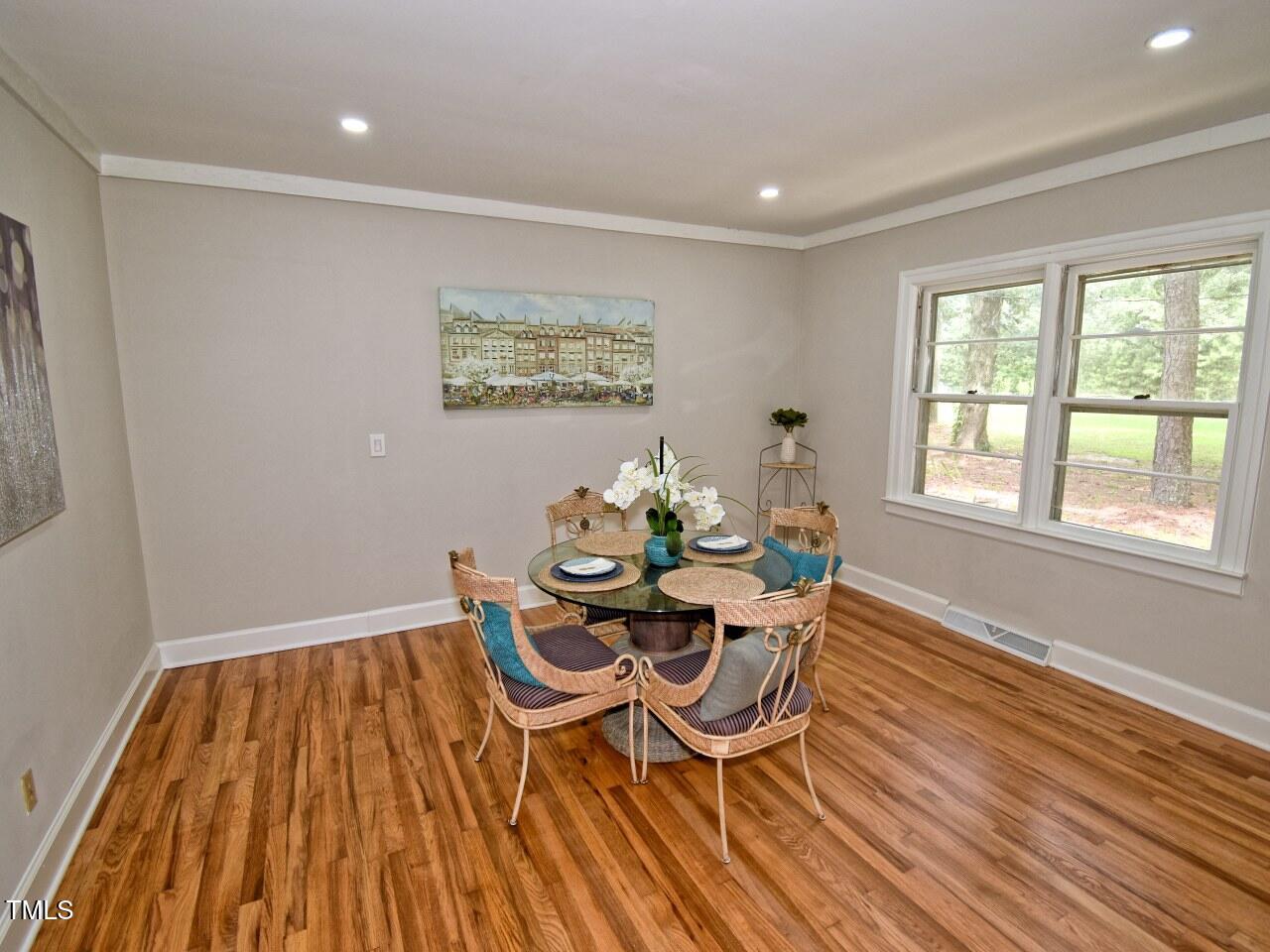 906 Perry Road Zebulon, NC 27597 - Photo 10 of 36 a dining room with furniture and wooden floor