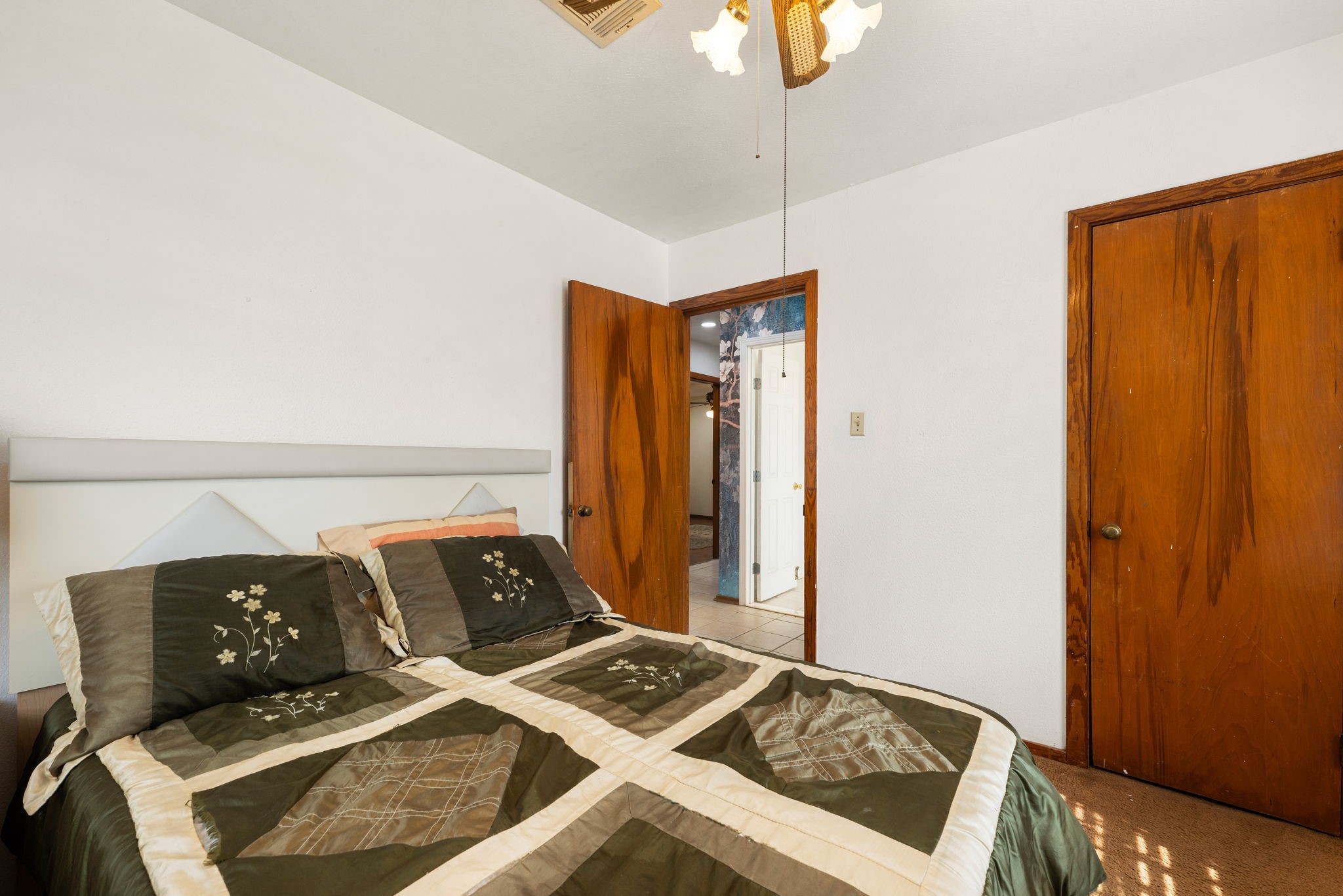 10923 Duane Street Houston, TX 77047 - Photo 11 of 22 a bedroom with a bed and a chandelier