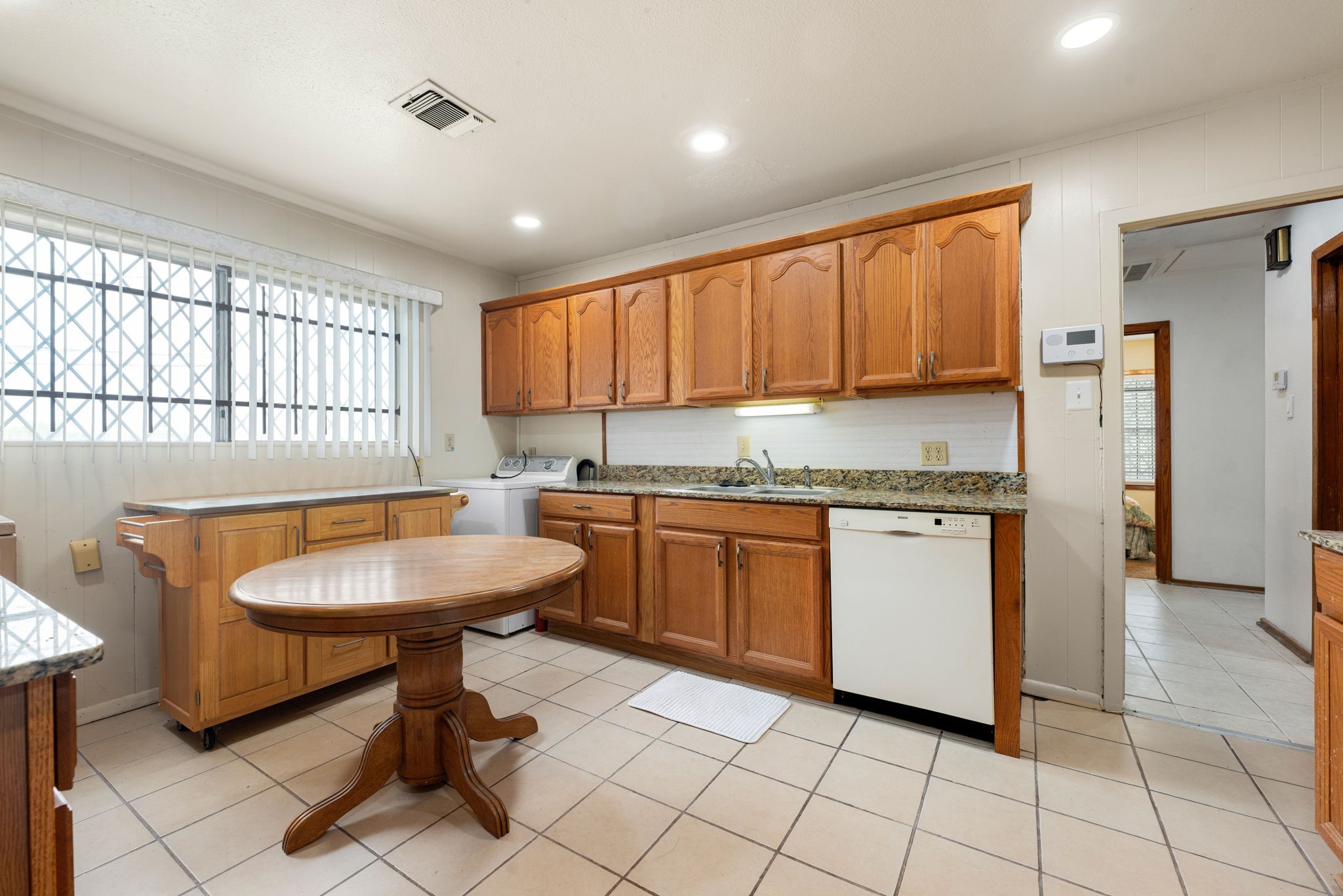 10923 Duane Street Houston, TX 77047 - Photo 18 of 22 a kitchen with sink cabinets and window
