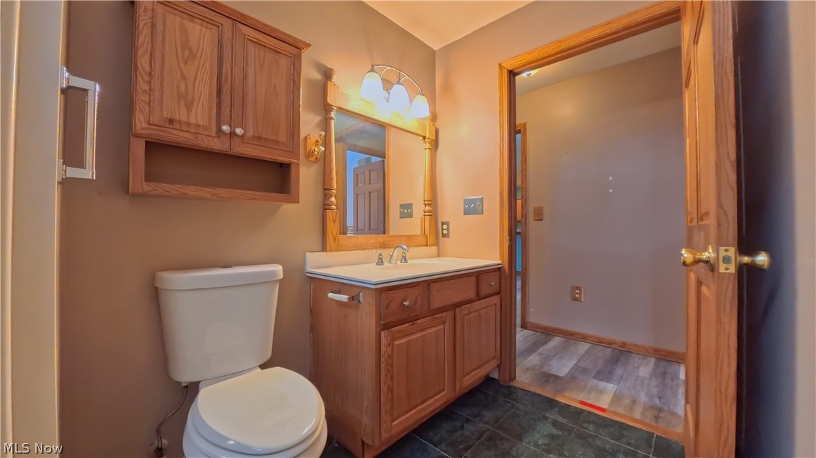 48276 Dyke Road Negley, OH 44441 - Photo 19 of 30 Half bath with vanity and dark tile patterned flooring