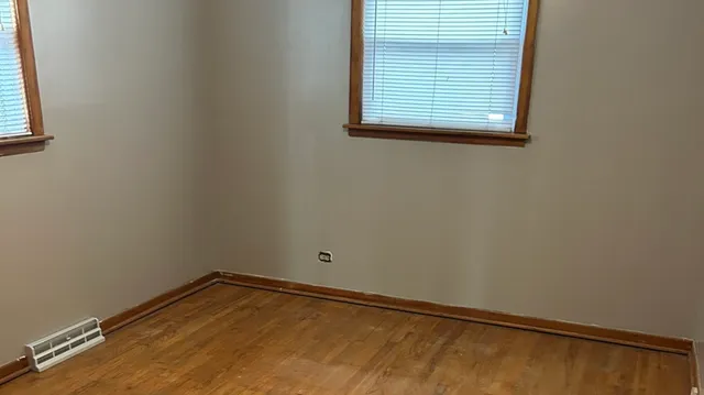 a kitchen with granite countertop white cabinets and a sink