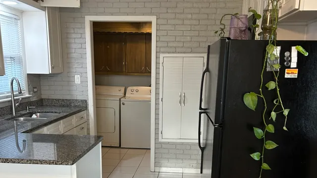 a kitchen with sink and cabinets