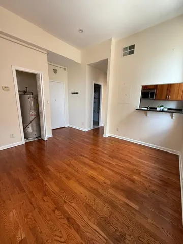 a kitchen with granite countertop a refrigerator and a sink