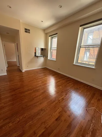 a view of walk in closet with wooden floor
