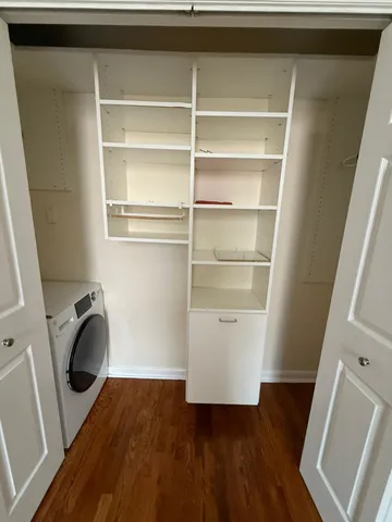 a view of walk in closet with empty racks