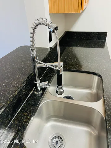 a kitchen with granite countertop a stove and a microwave