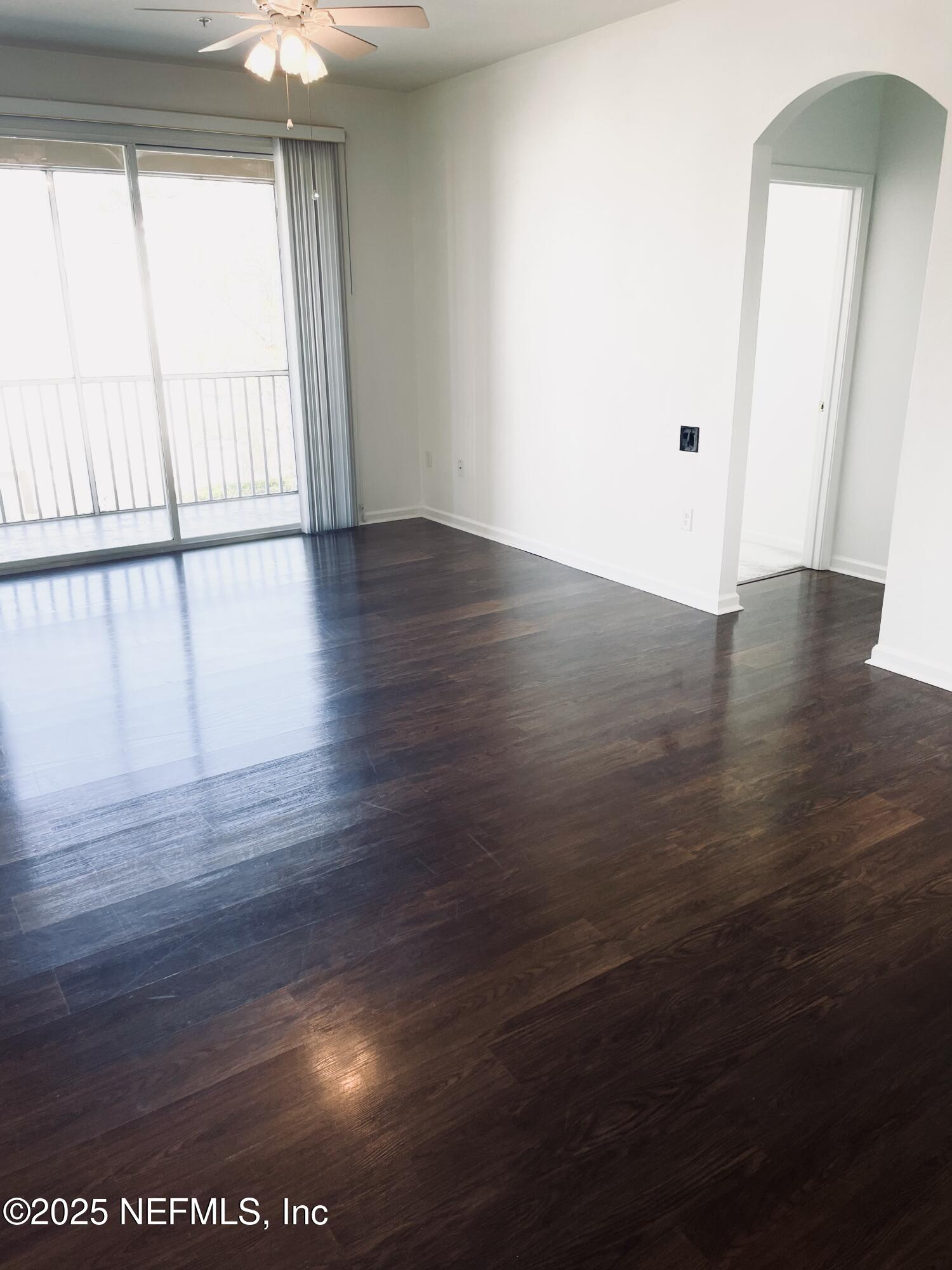 7990 Baymeadows Road East, Unit 426 Jacksonville, FL 32256 - Photo 13 of 19 an empty room with wooden floor and windows