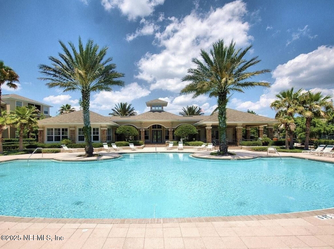 7990 Baymeadows Road East, Unit 426 Jacksonville, FL 32256 - Photo 17 of 19 a view of a swimming pool with a table and chairs