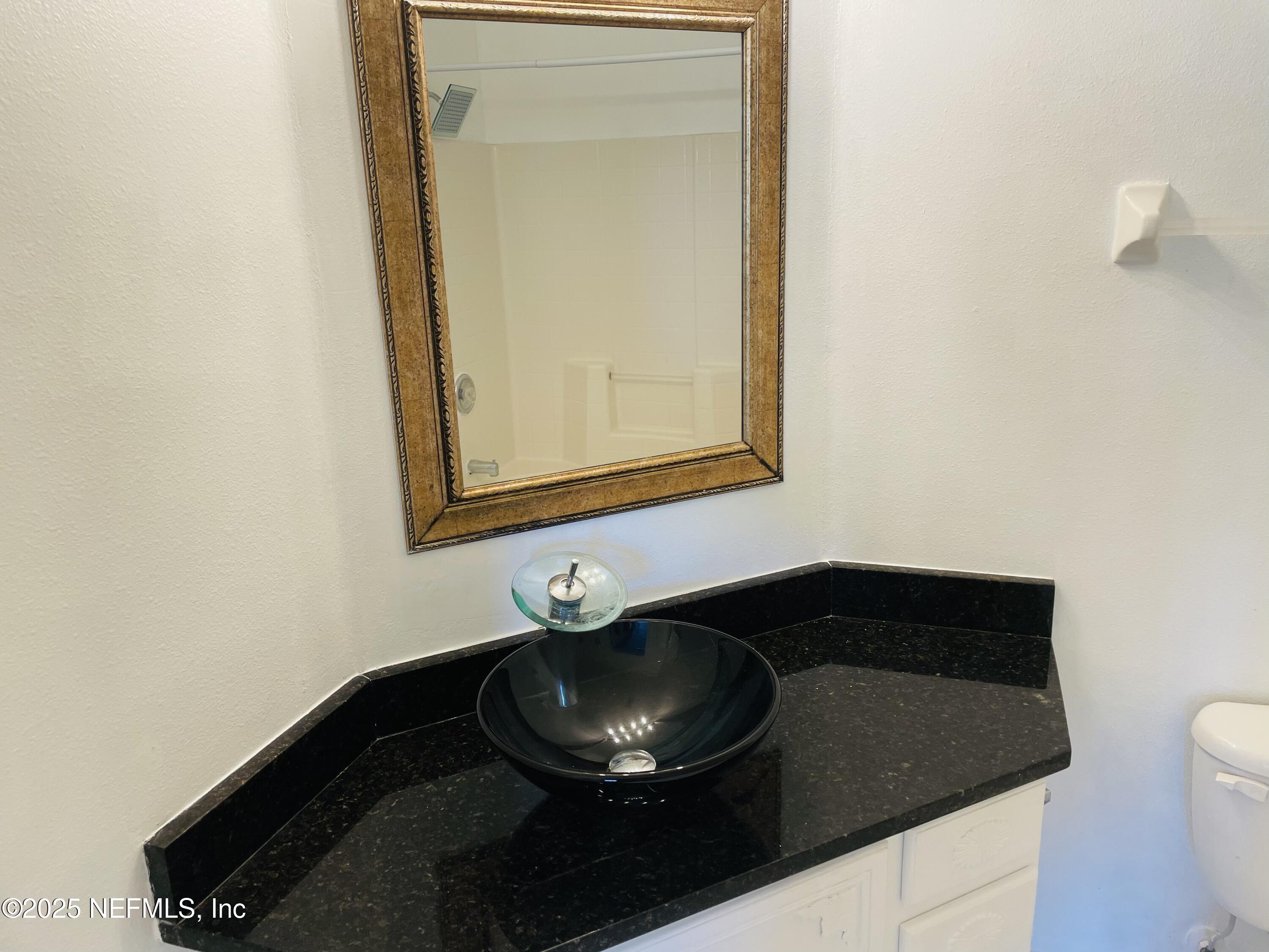 7990 Baymeadows Road East, Unit 426 Jacksonville, FL 32256 - Photo 3 of 19 a bathroom with a sink and a mirror