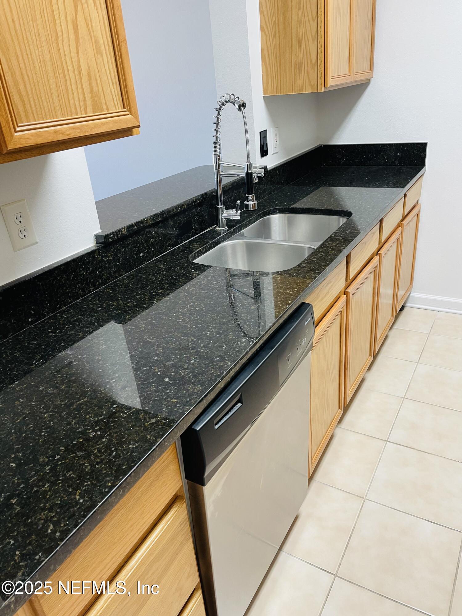 7990 Baymeadows Road East, Unit 426 Jacksonville, FL 32256 - Photo 8 of 19 a kitchen with granite countertop a sink and a stove