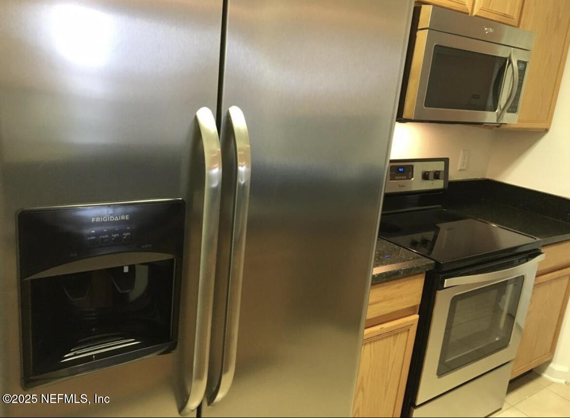 7990 Baymeadows Road East, Unit 426 Jacksonville, FL 32256 - Photo 9 of 19 a kitchen with a stove and a microwave