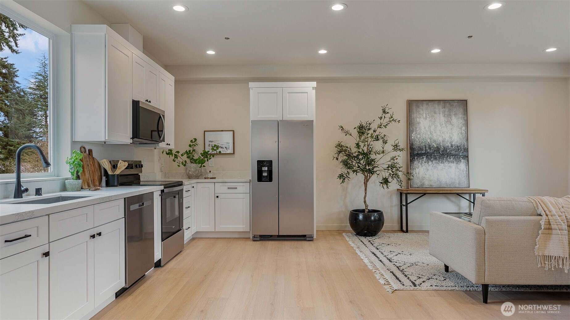 225 106th Street Southwest, Unit A2 Everett, WA 98204 - Photo 5 of 26 a kitchen with a sink stainless steel appliances and cabinets