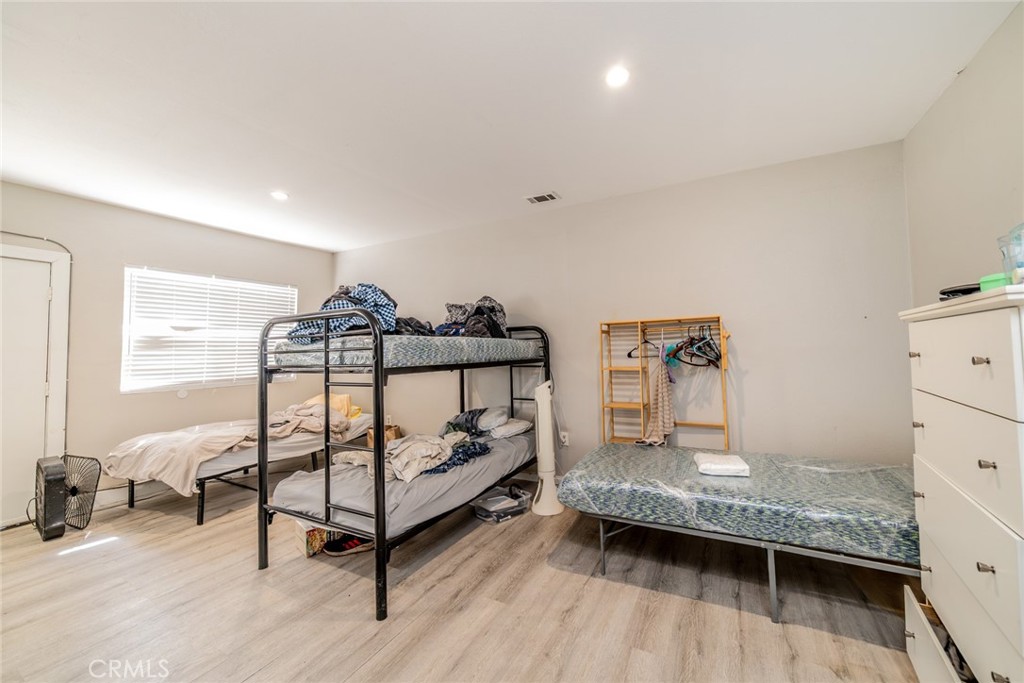 732 South Acacia Avenue Rialto, CA 92376 - Photo 13 of 30 a bedroom with a bed and a night stand
