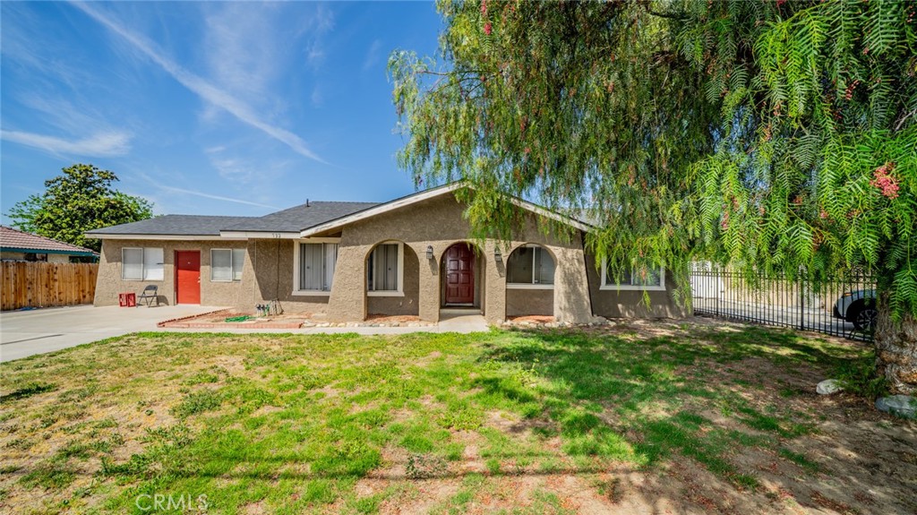732 South Acacia Avenue Rialto, CA 92376 - Photo 2 of 30 a front view of a house with a yard and garage