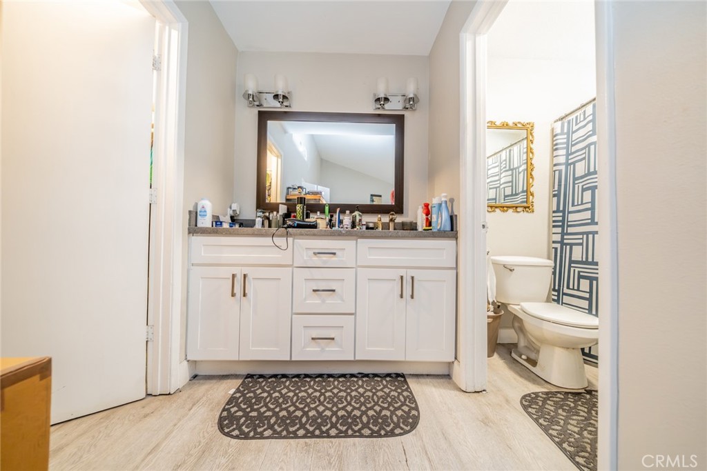 732 South Acacia Avenue Rialto, CA 92376 - Photo 9 of 30 a bathroom with a toilet a sink and a mirror