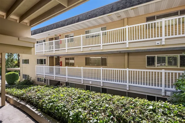 a view of a house with a flower garden in front of it
