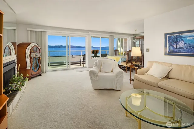 a living room with furniture a window and a flat screen tv