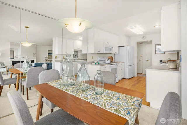 a open kitchen with granite countertop a sink and white cabinets