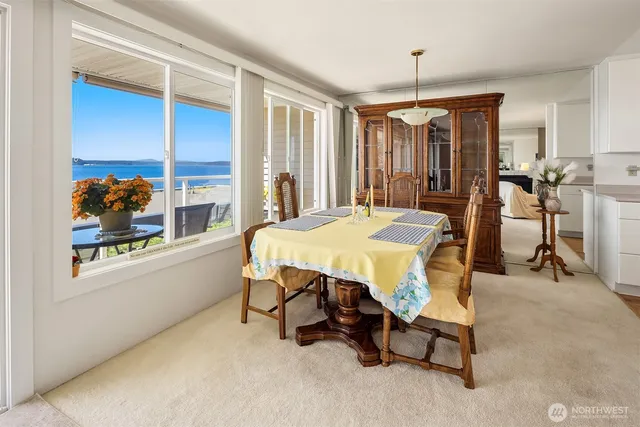 a dining room with furniture and a chandelier