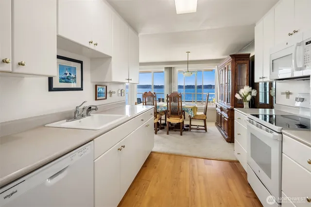 a kitchen with sink cabinets and dining table