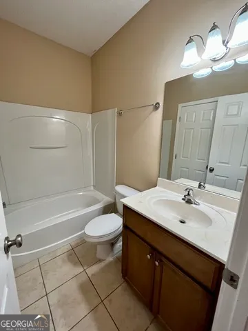 a bathroom with a double vanity sink mirror and shower