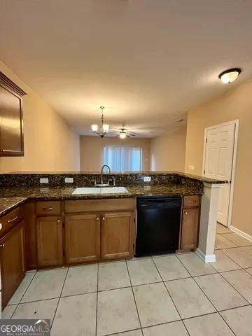 a kitchen with a stove a refrigerator and a sink