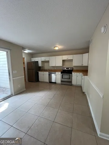 a view of empty room with a ceiling fan and window