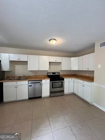 a bathroom with a toilet a sink a mirror and a bathtub