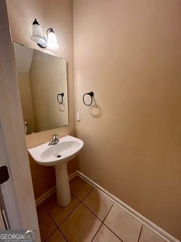 a view of a room with gym equipment and a chandelier