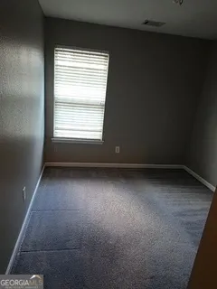 a bathroom with a toilet sink vanity and a mirror