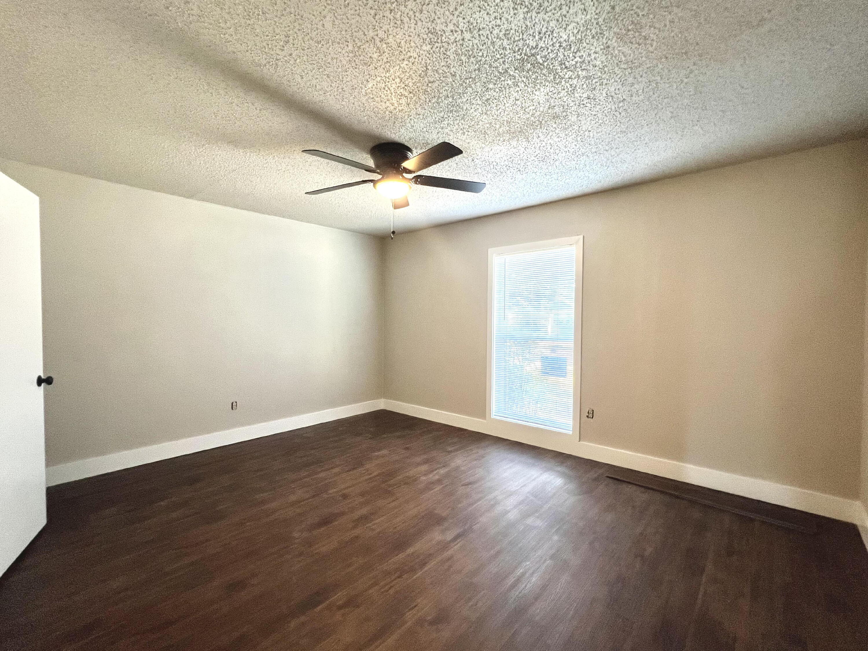 2620 25th Street Lubbock, TX 79410 - Photo 15 of 16 an empty room with wooden floor and windows
