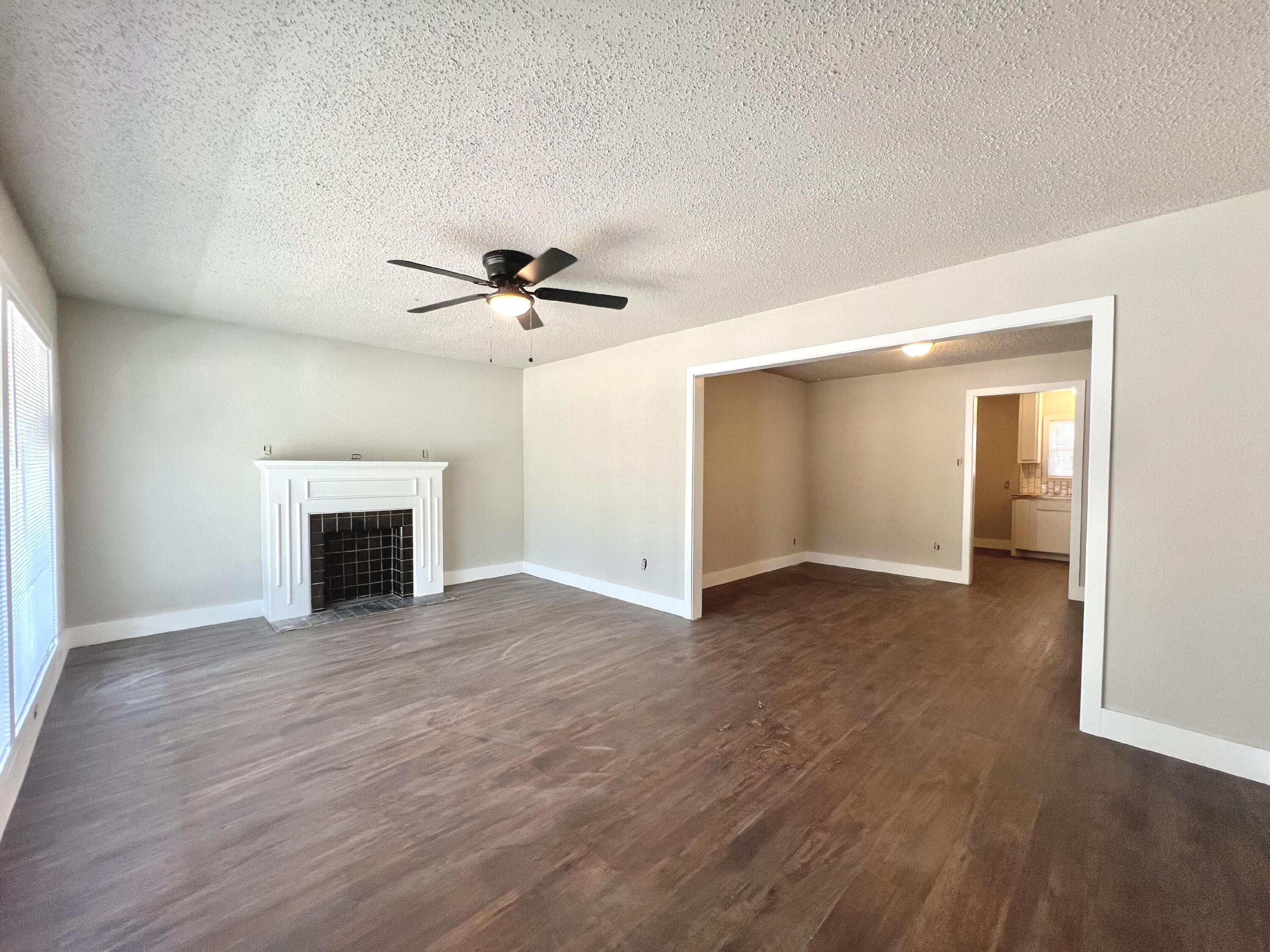 2620 25th Street Lubbock, TX 79410 - Photo 2 of 16 wooden floor fireplace and windows in an empty room
