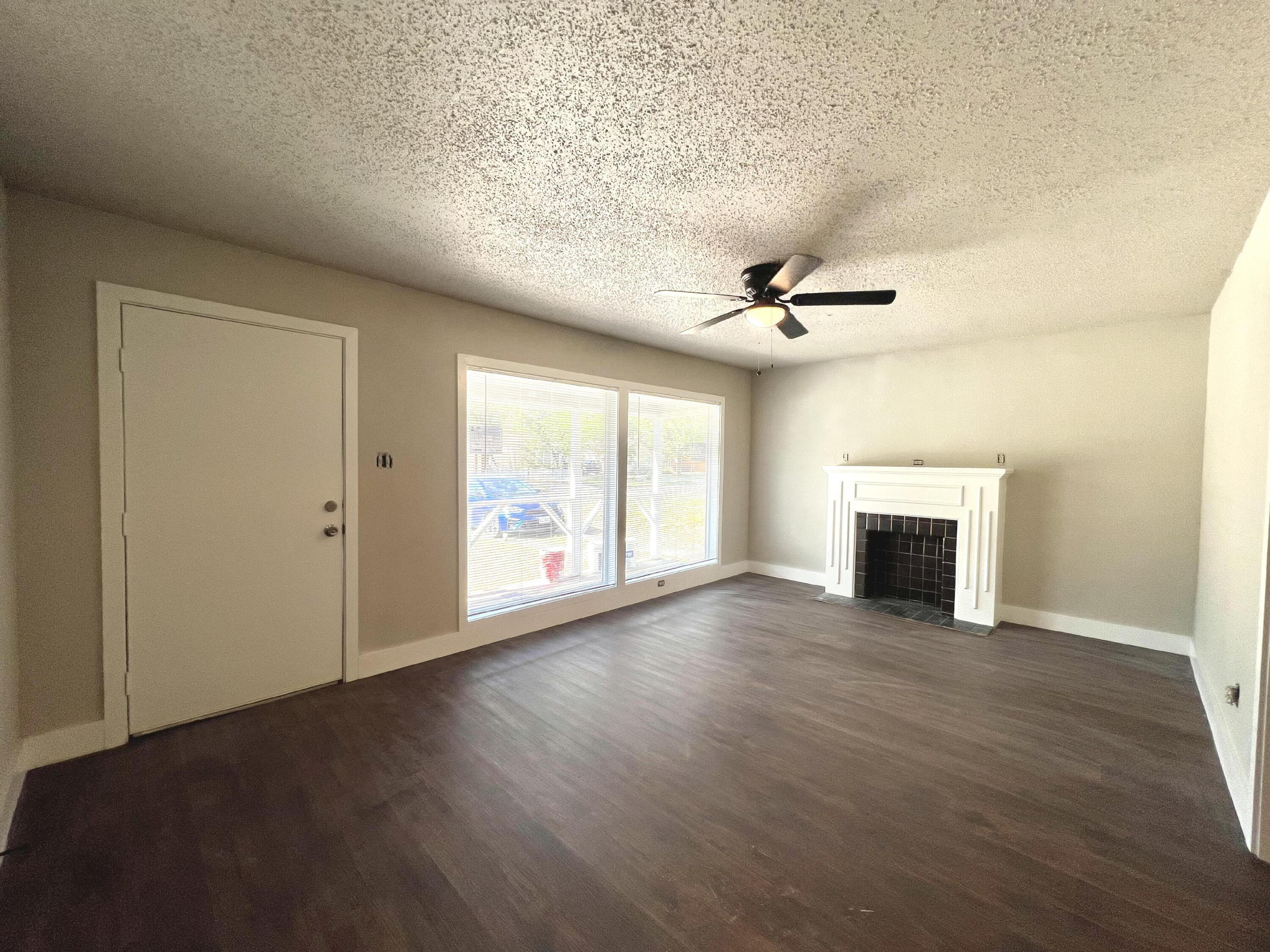 2620 25th Street Lubbock, TX 79410 - Photo 3 of 16 an empty room with windows and fireplace