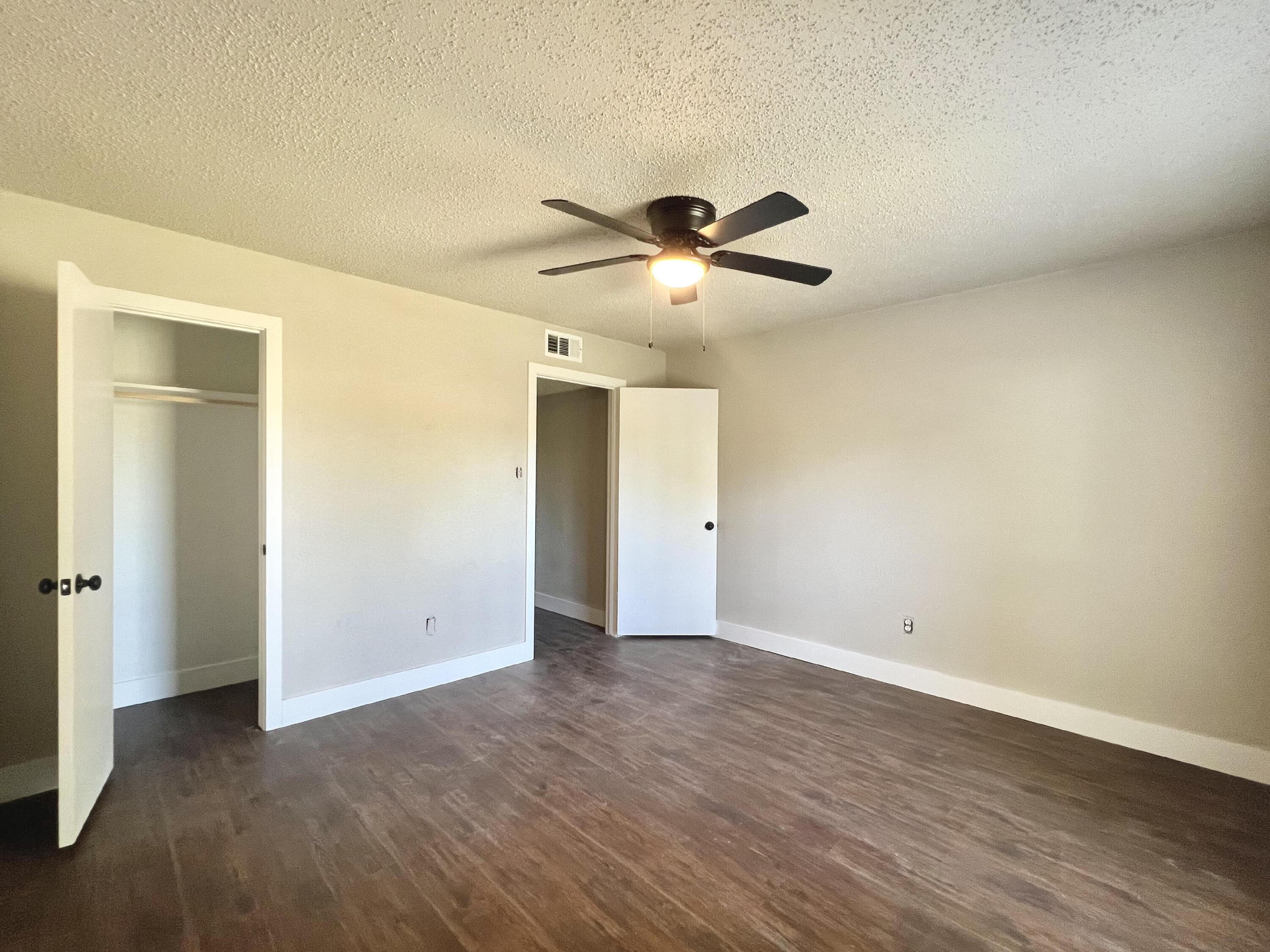 2620 25th Street Lubbock, TX 79410 - Photo 9 of 16 an empty room with wooden floor chandelier fan and closet area